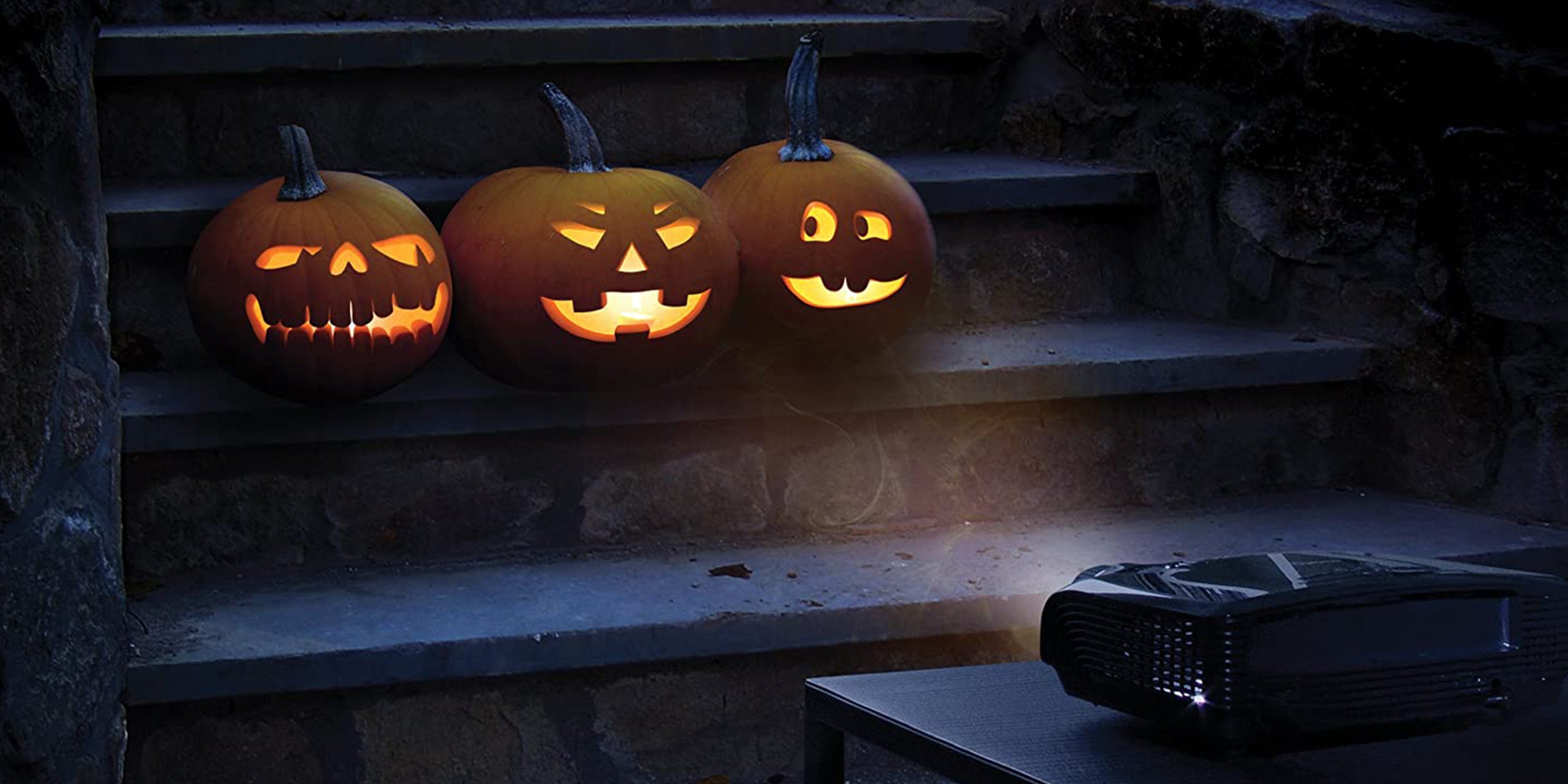 Charming jack-o-lantern trio projected onto walkway