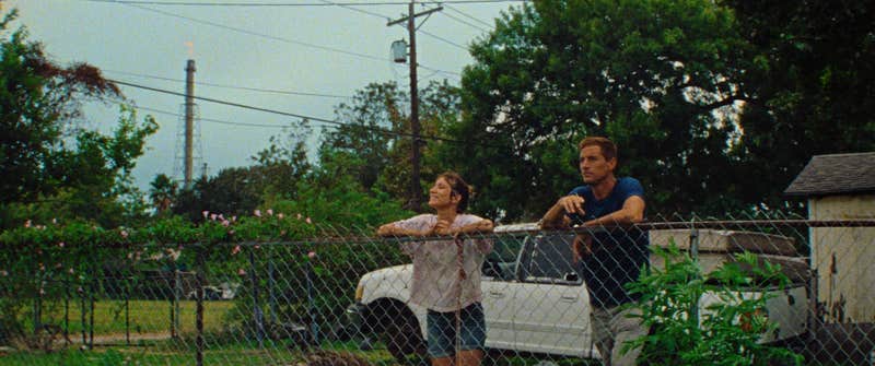 woman and man leaning on fence in red rocket