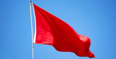 red flag blowing in the wind