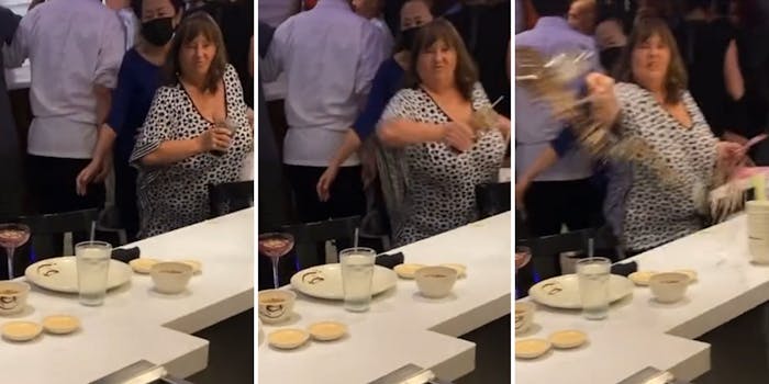 grown woman throws a drink at another patron in a restaurant