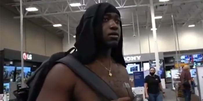 man wearing shirt on his head in electronics store