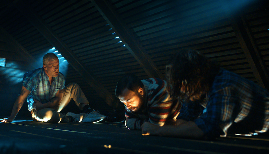 three men in an attic in the trip