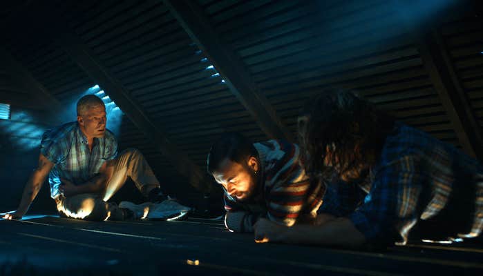 three men in an attic in the trip