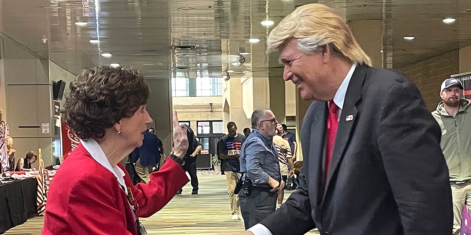 woman shaking hands with Trump impersonator