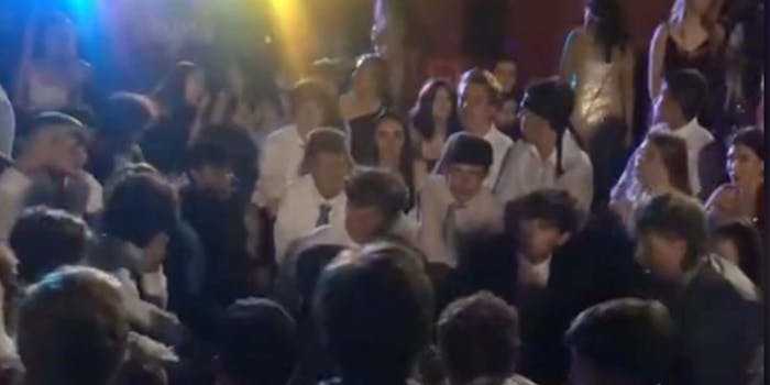 In a TikTok, white high schoolers are seen kneeling while a song in Spanish plays at a homecoming dance.