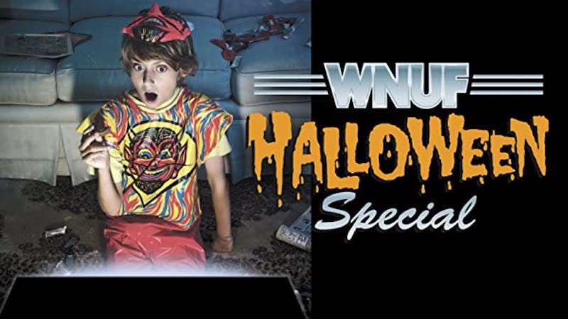 WNUF Halloween Special shudder - a scared woman sits on a sofa watching a TV special