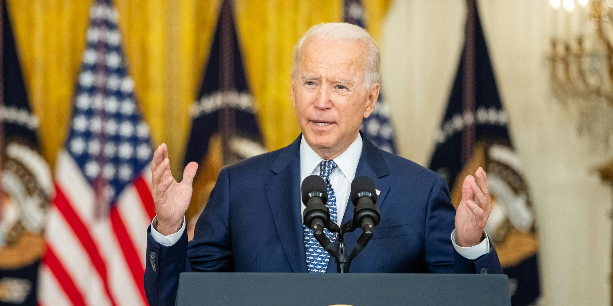 President Joe Biden speaking at a podium.