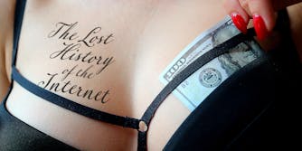 $100 bill tucked in bra of woman with "The Lost History of the Internet" tattooed on her chest