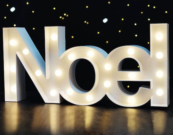 Christmas home decor: 'Noel' marquee sign lit up against a dark background
