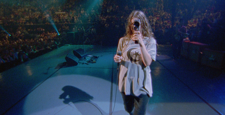 alanis morissette holding a camera