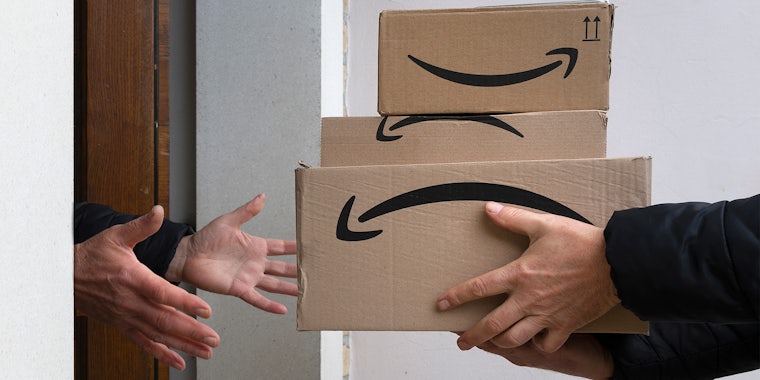 person handing amazon packages to another