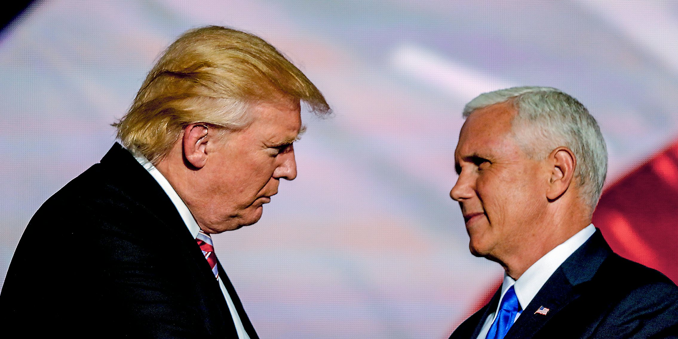 Donald Trump and Mike Pence looking at each other.