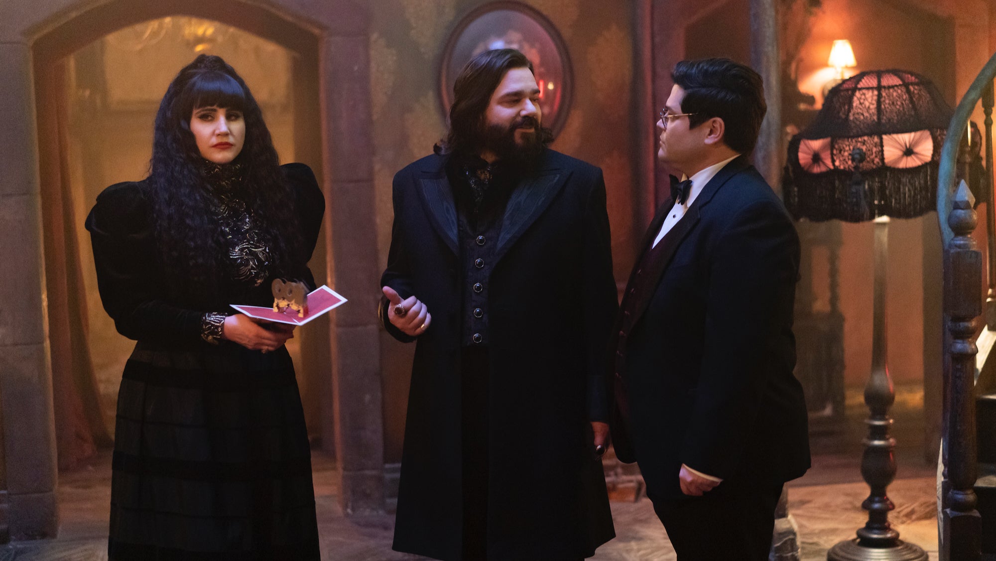 two vampires and a human in fancy attire