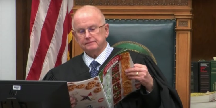 Judge Bruce Schroeder reading a magazine