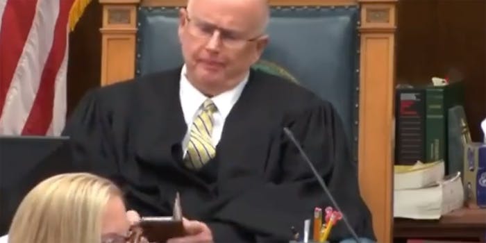 A judge looking at his phone.