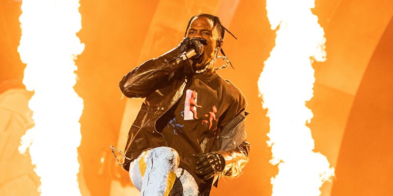 travis scott performing with flames in background