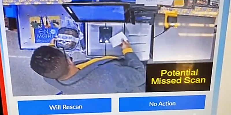 A man using a self checkout machine.