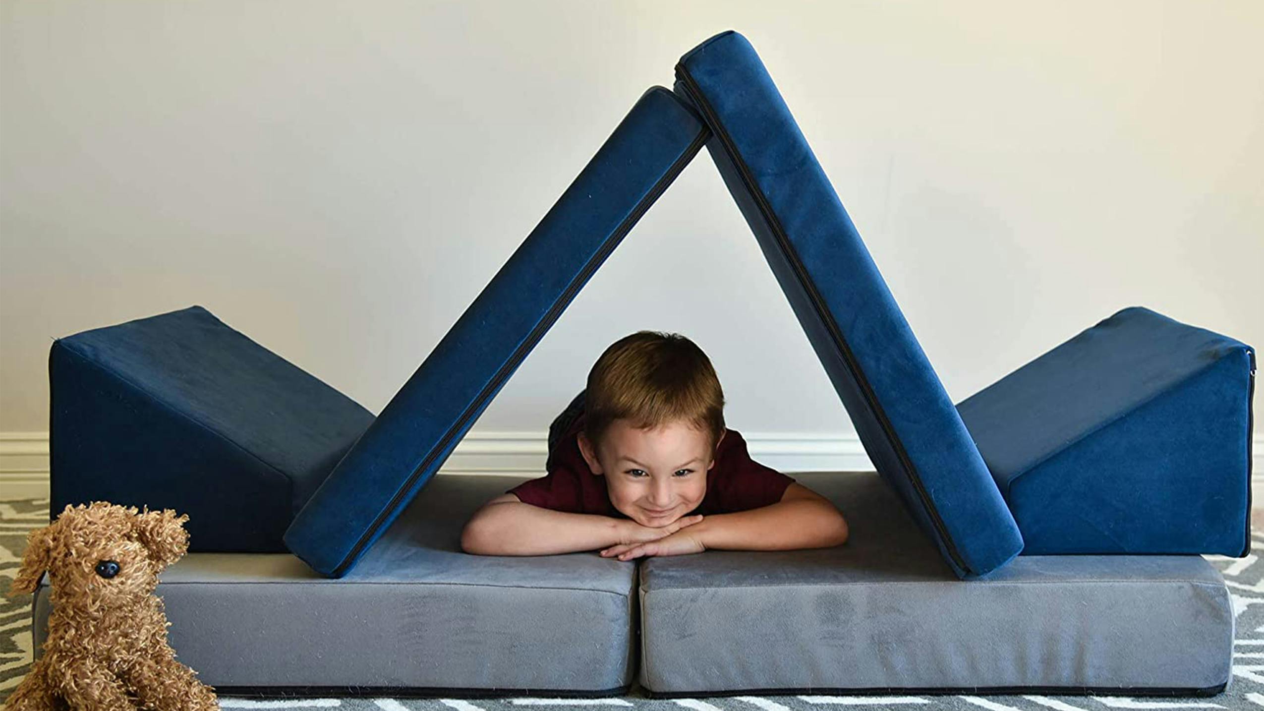 A kid perched inside of a Whatsit couch.