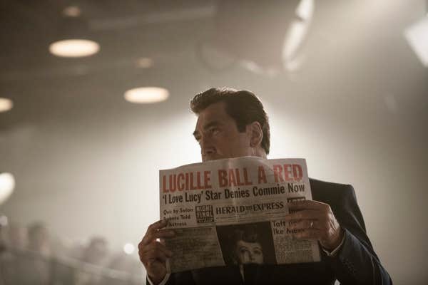 desi arnaz holding a newspaper in being the ricardos