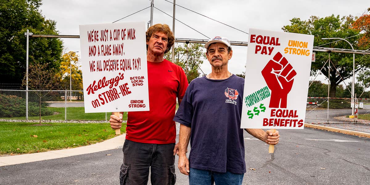 Two men with protest signs.