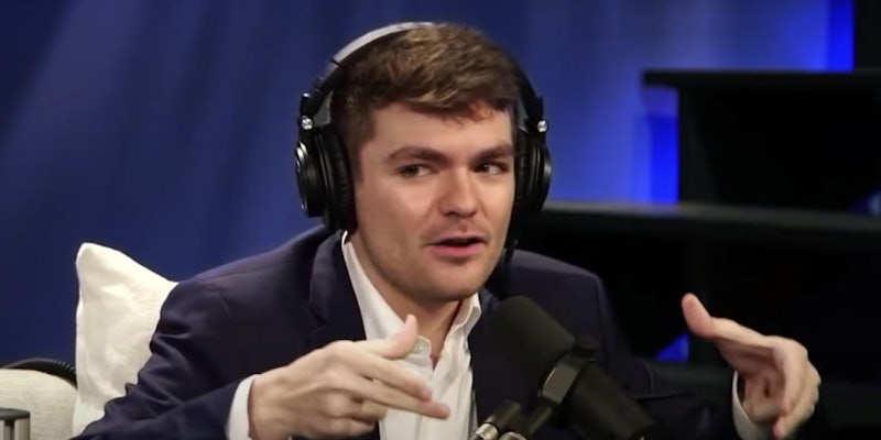 photo of nick fuentes looking like he was caught in a really awkward scenario