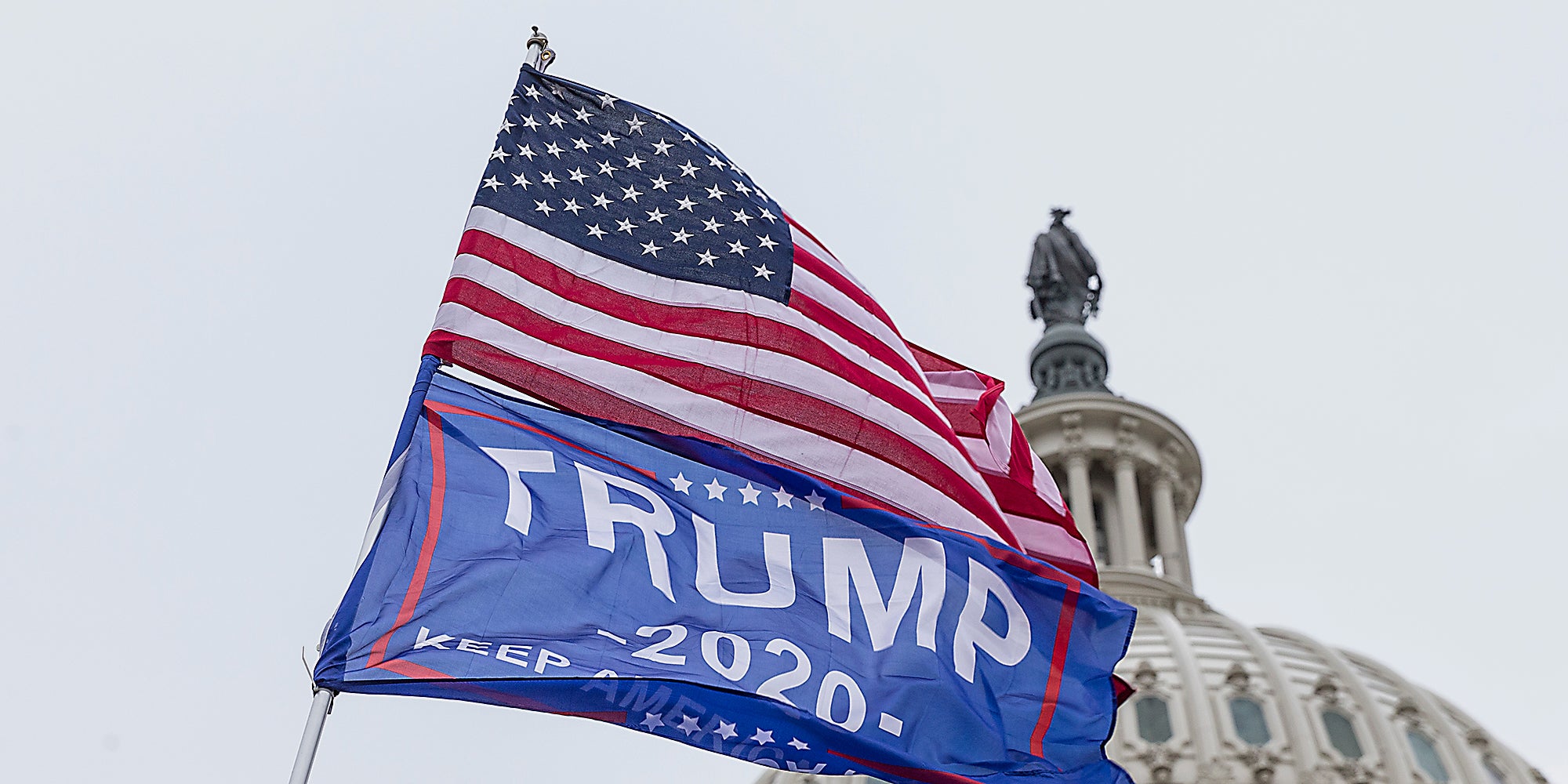 A United States flag and Trump 2020 flag.