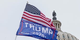 A United States flag and Trump 2020 flag.