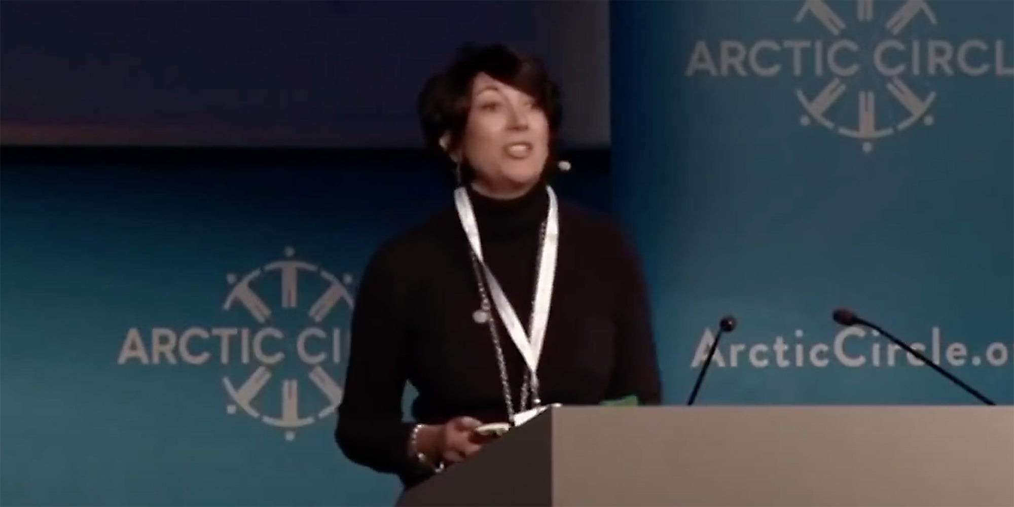 Ghislaine Maxwell at a podium.