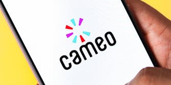 hand holding phone with cameo logo