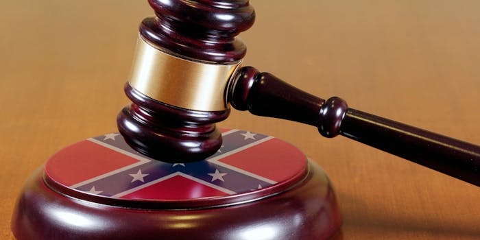 a gavel hitting a wooden platform that looks like the confederate flag