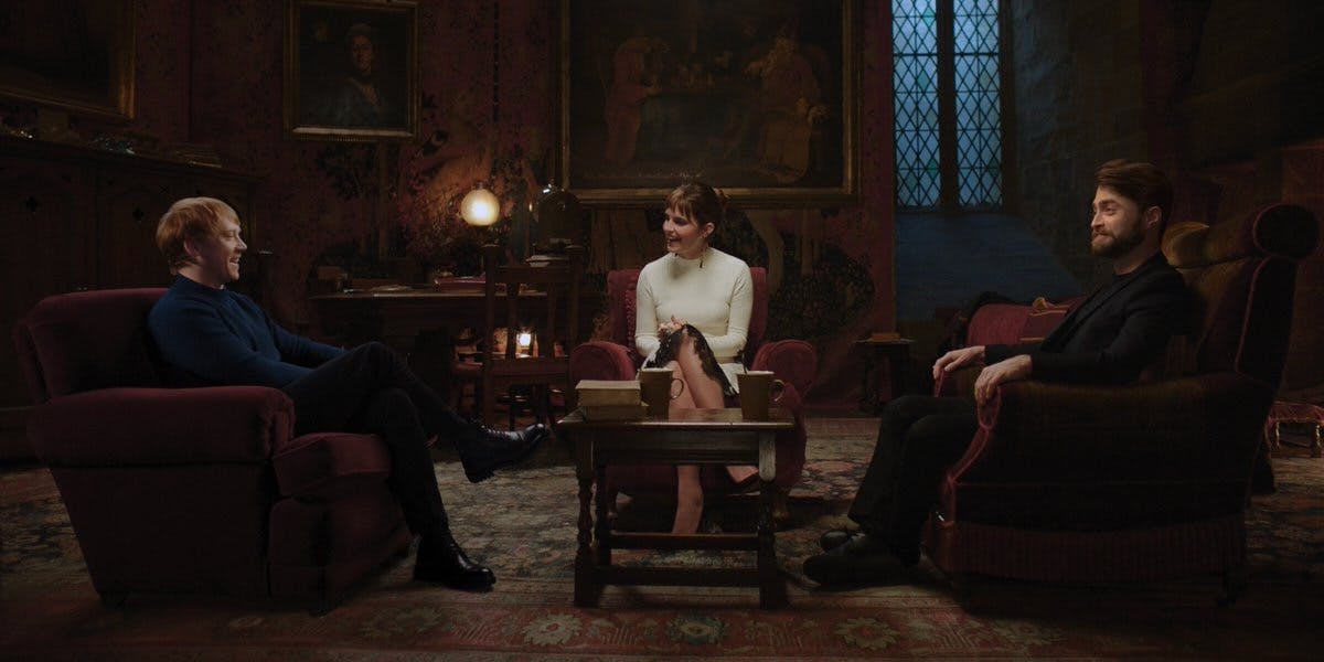 (l-r) rupert grint, emma watson, and daniel radcliffe sitting around a table and talking