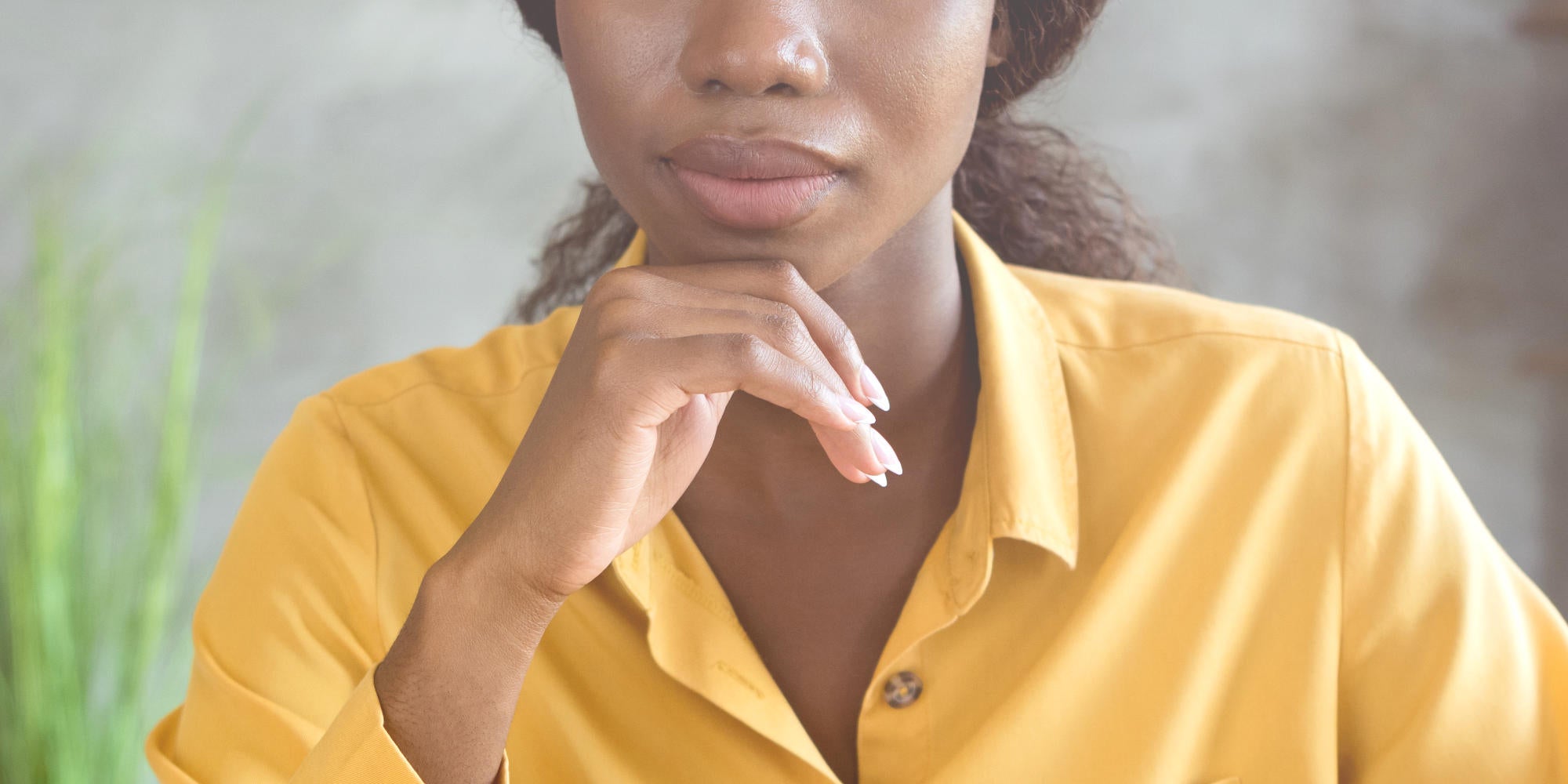 black business woman suspiciously holding her chin