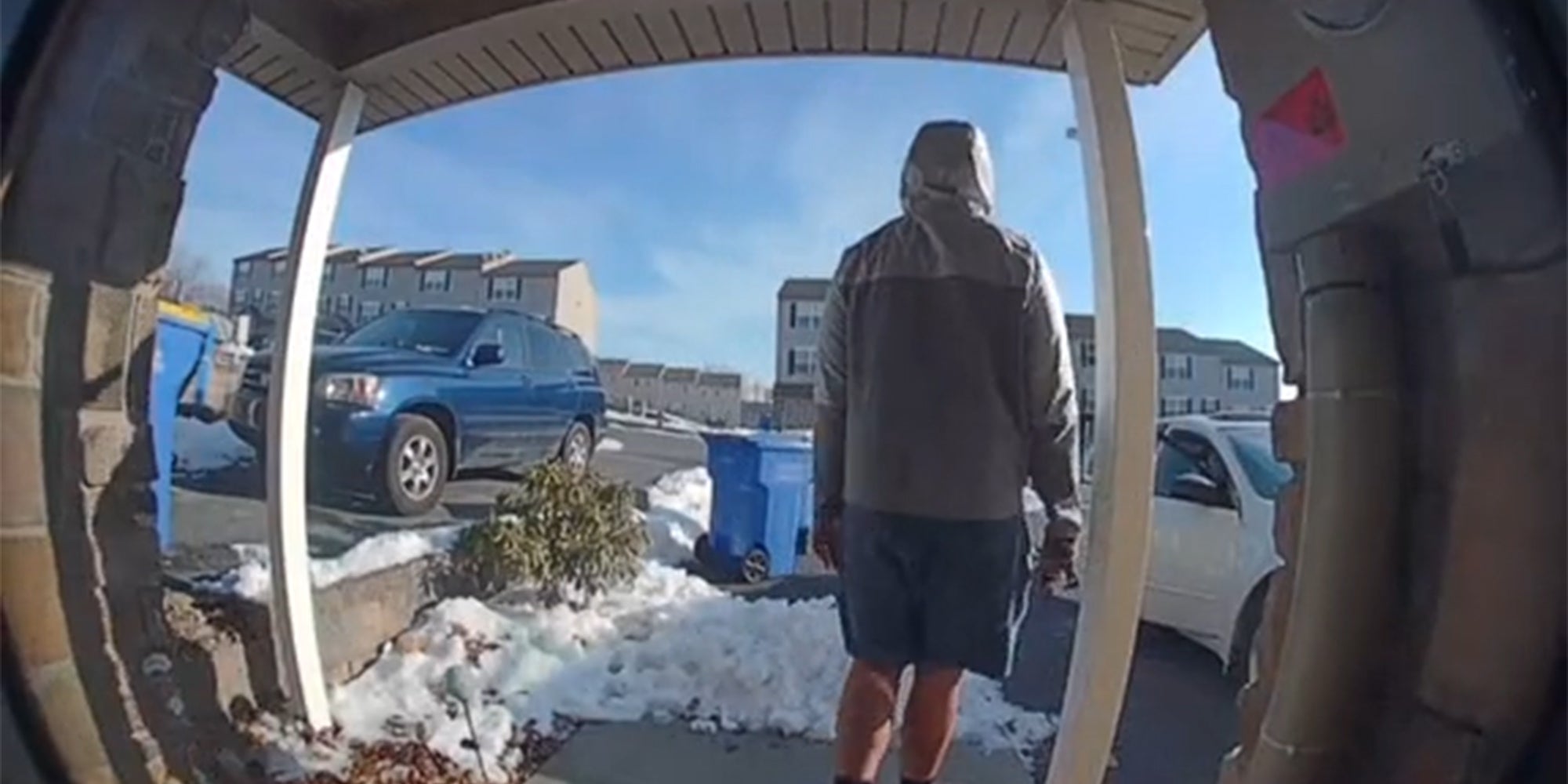 man in jacket walking toward person getting in car, captured by Ring camera