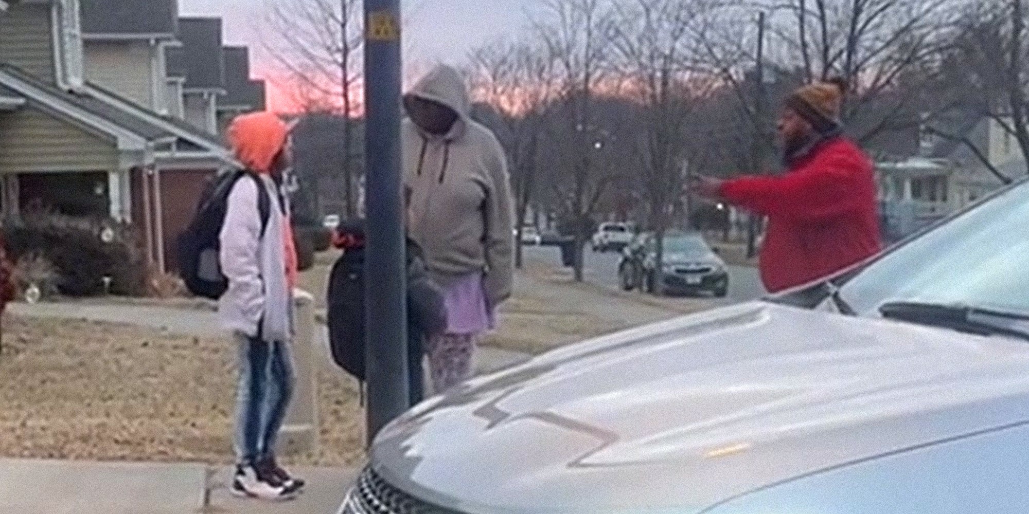 man pointing at adult and children