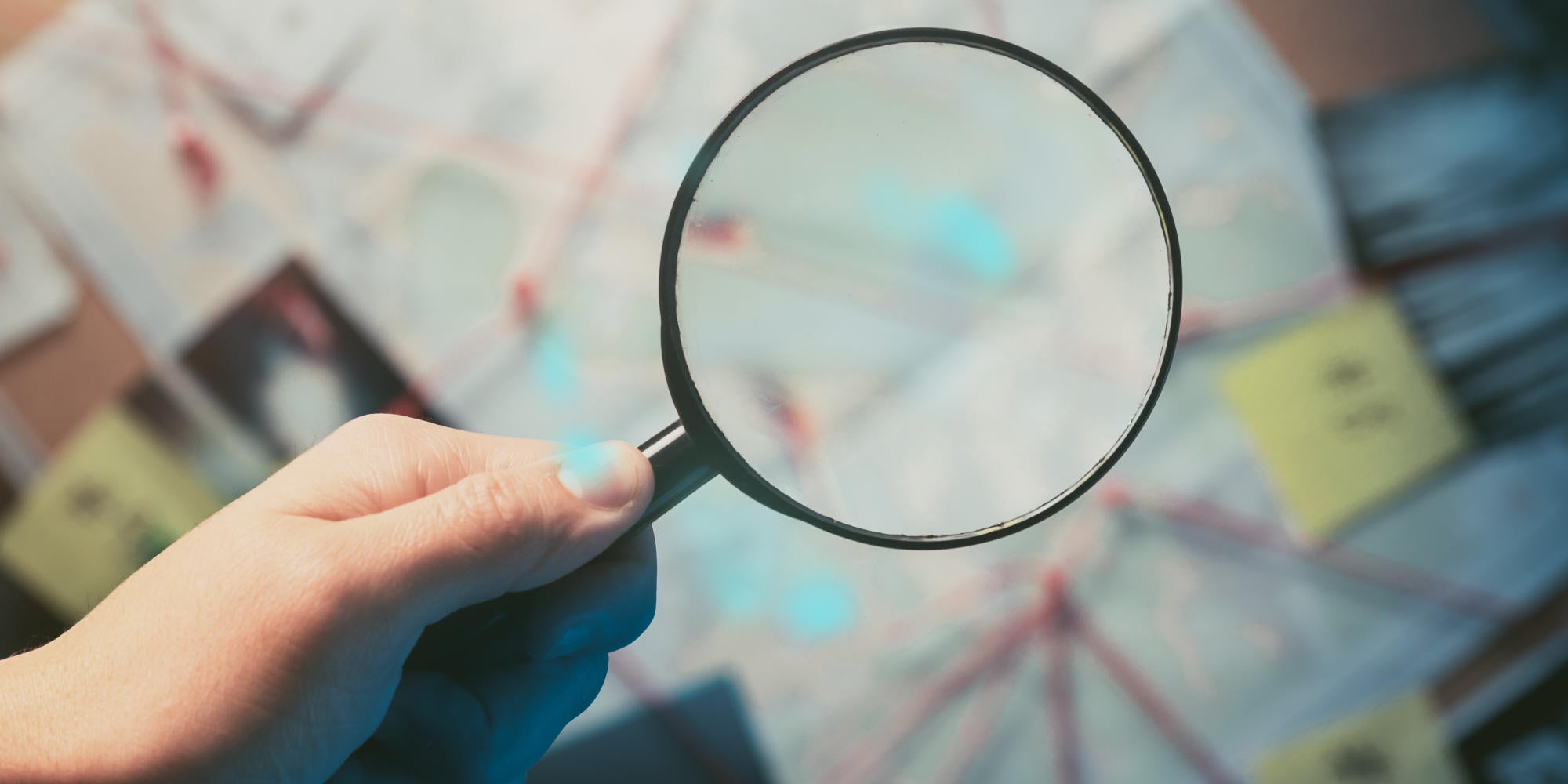 man holding up a magnifying glass