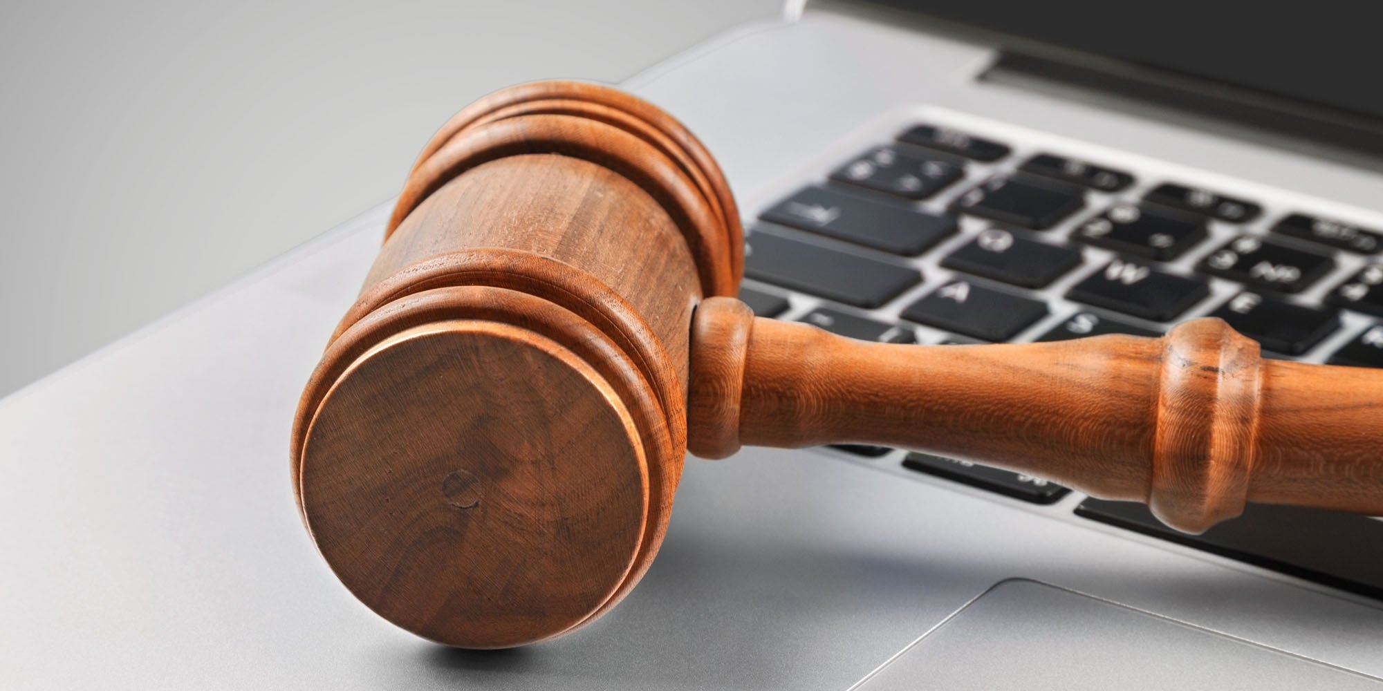 wooden gavel on laptop