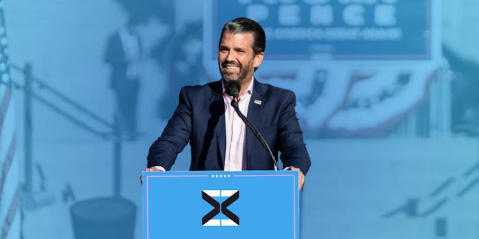 don trump jr on a podium with the mxm logo