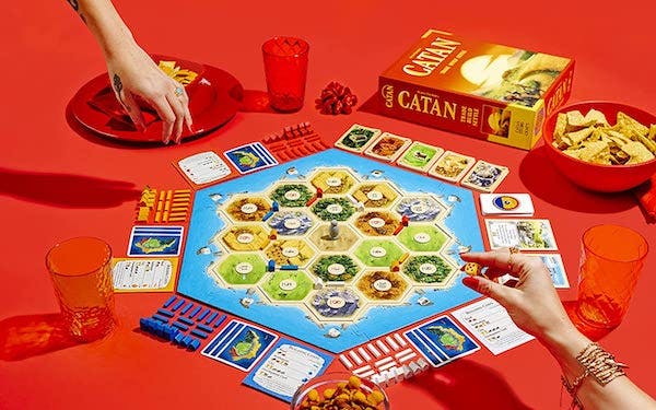Two people playing Settlers of Catan