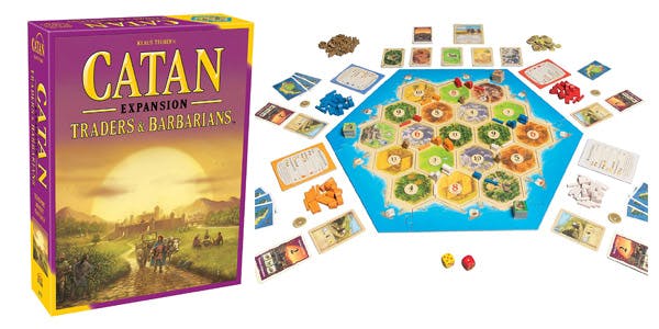 Settlers of Catan expansion pack Traders & Barbarians alongside game board and pieces