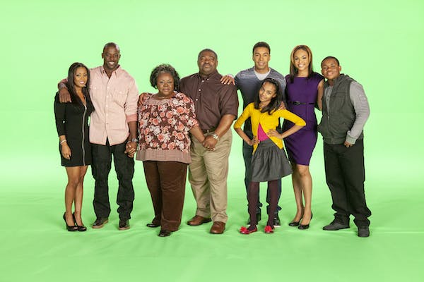 The cast of House of Payne pose in front of a green background