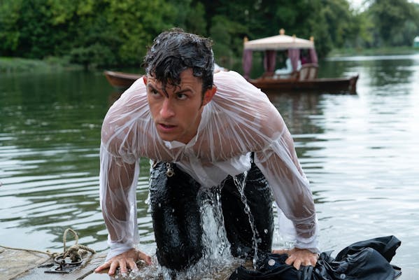 anthony bridgerton climbing out of a lake in a wet shirt in bridgerton