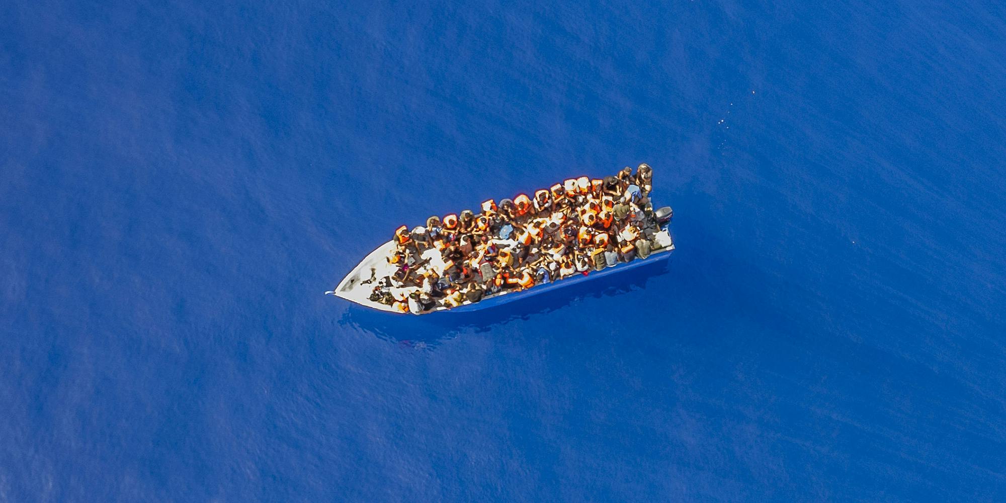 A small wooden boat filled with people