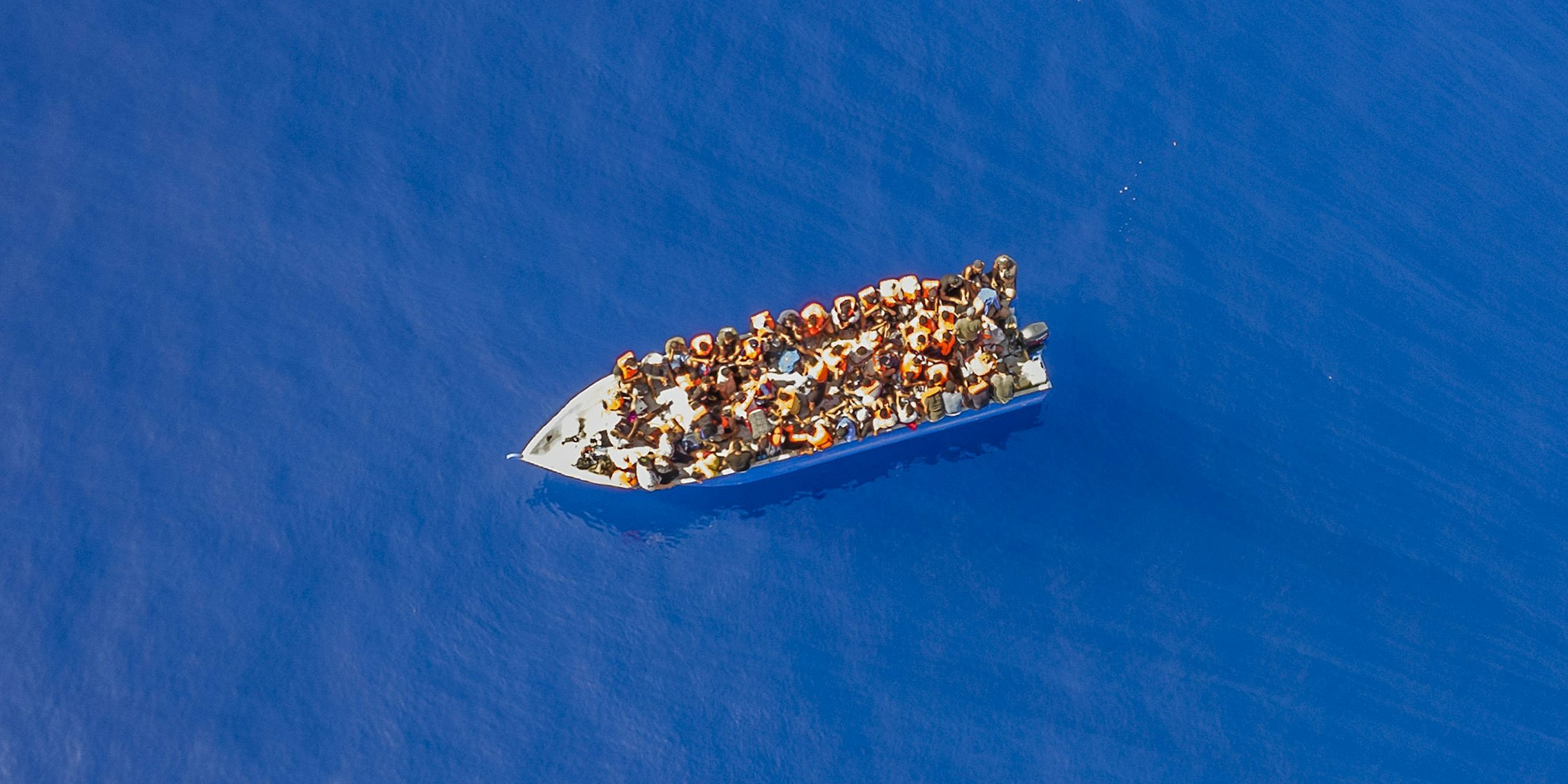 A small wooden boat filled with people