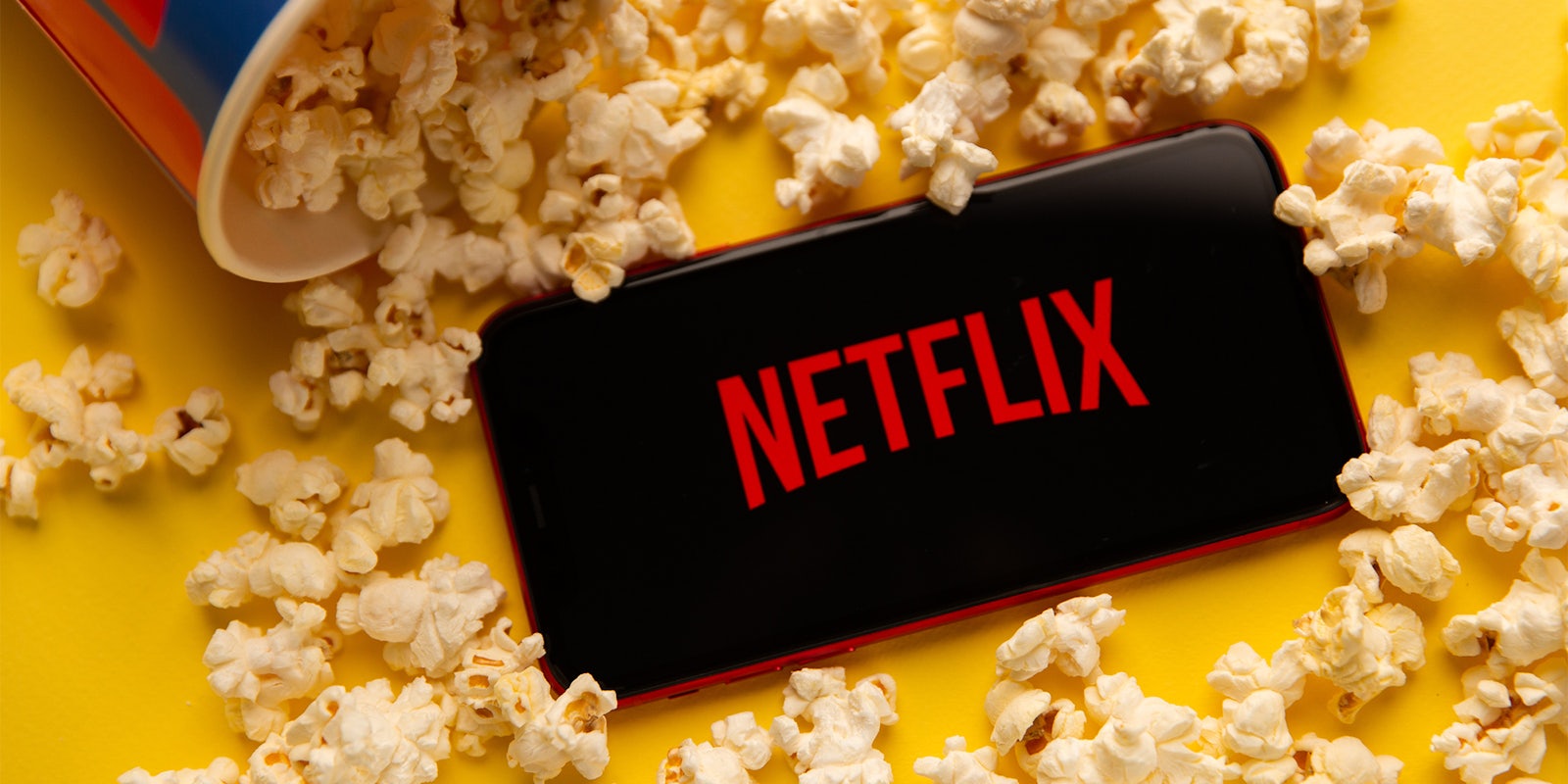 Netflix logo on phone with popcorn