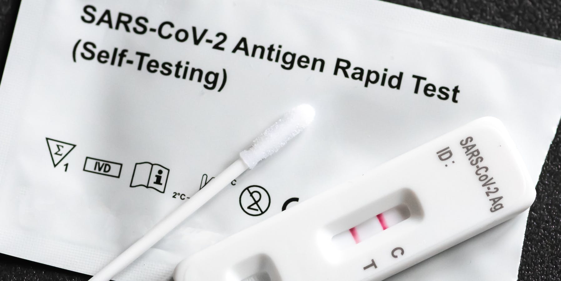Positive SARS‑CoV‑2, Covid-19 antigen test kit, one step coronavirus antigen rapid test, saliva swab, 1 test box with imagine of lungs, close up