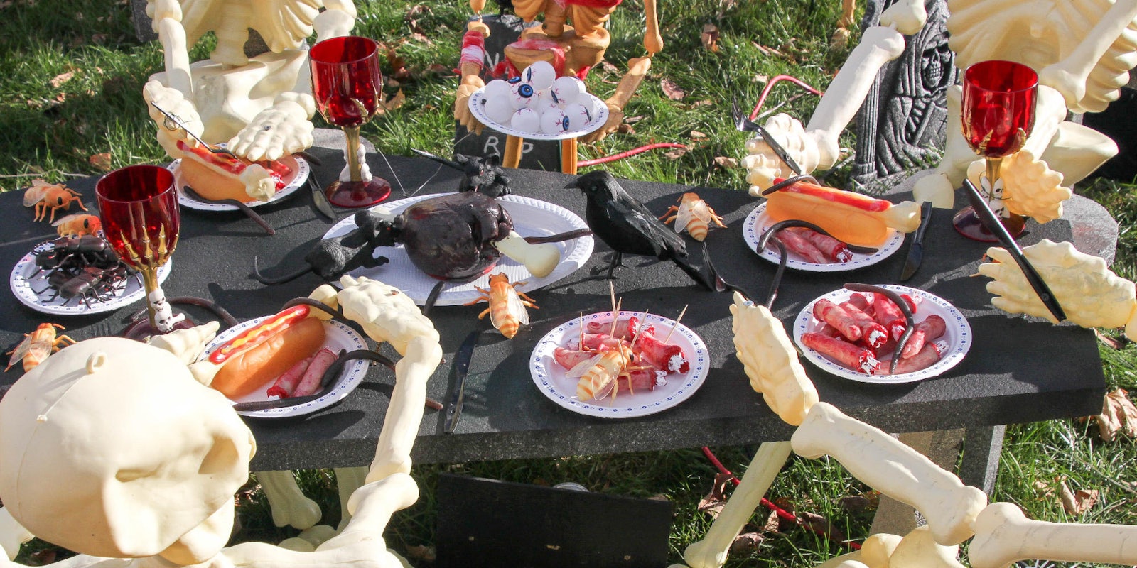 photo of skeletons eating around a table