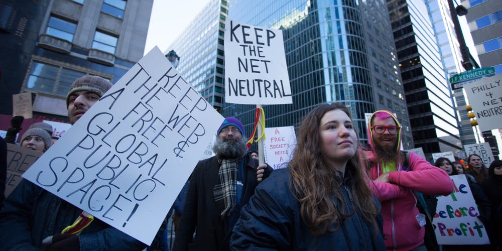 Protestors advocating for net neutrality rally outside the headquarters of the Comcast Corporation