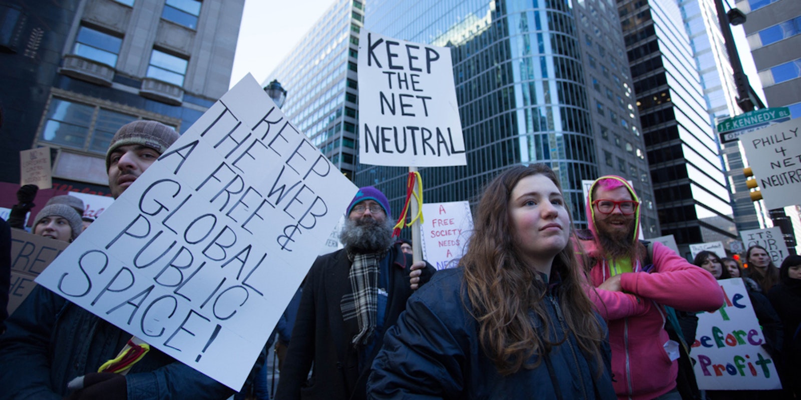 Protestors advocating for net neutrality rally outside the headquarters of the Comcast Corporation
