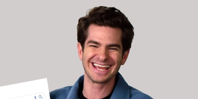 Andrew Garfield laughing paper in hand