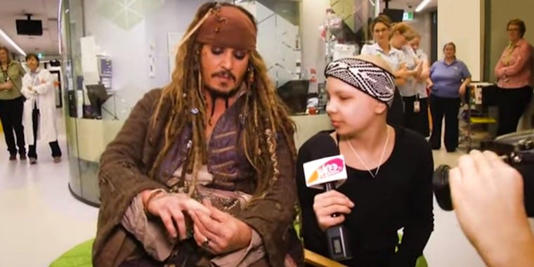 Johnny Depp showing young girl his finger while in costume